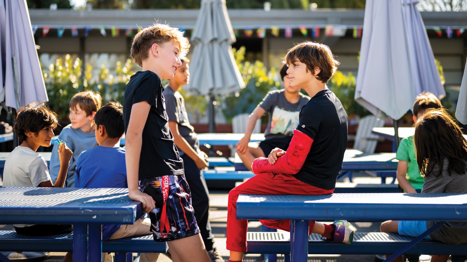 Middle schoolers sitting talking at lunch