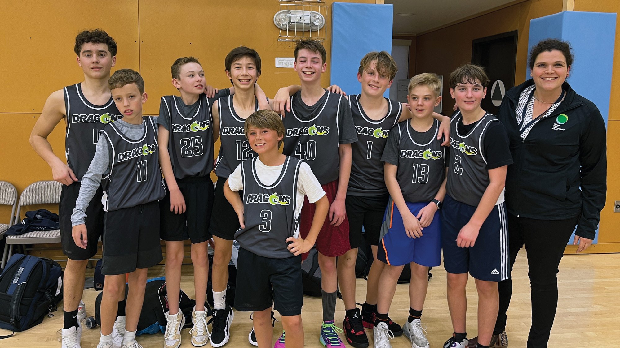 A team photo of the 7th and 8th Grade boys basketball team after a game.