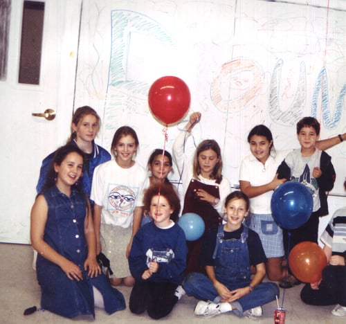 Mandy with friends at school holding balloons