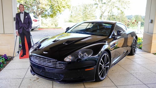 The black Aston Martin parked outside of the venue