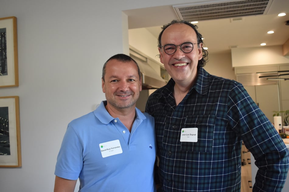 Two Men Standing Together and Smiling