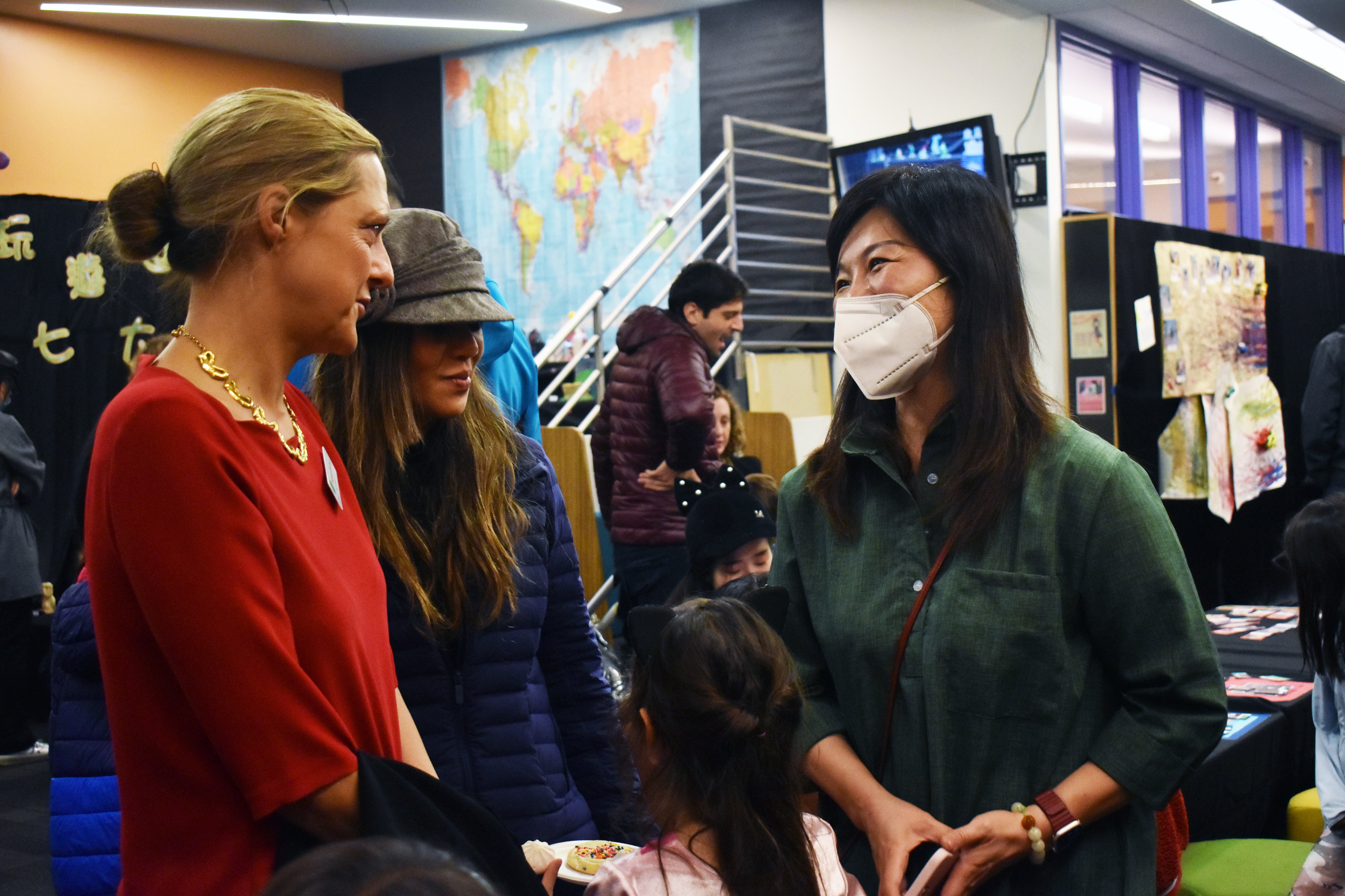 Head of School Barbara Greiner speaking with people at the event.