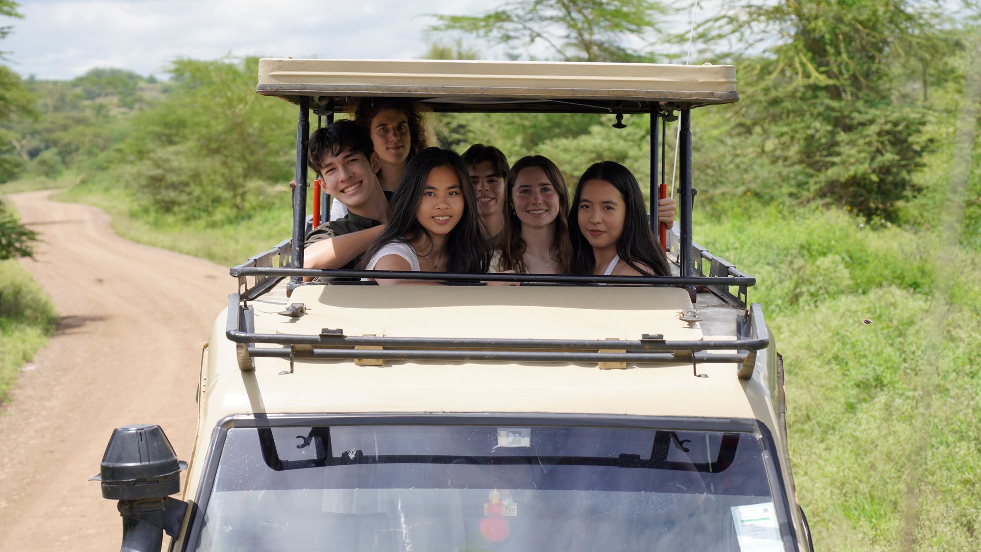 The six juniors from INTL standing out of the top of the game viewing vehicle during their safari.