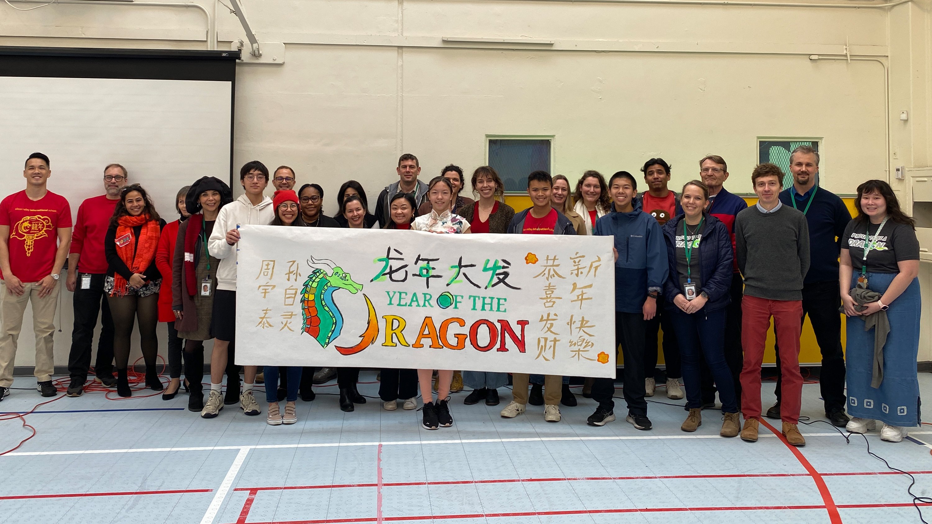 Upper School assembly with their hand painted Year of the Dragon banner.