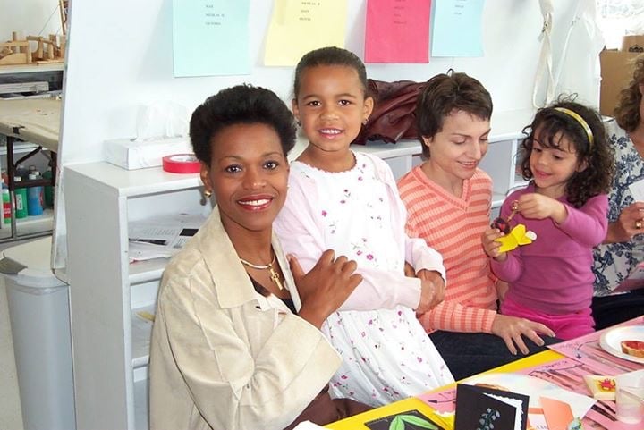 Alex Lyzwa and her mother posing for a photo in the classroom at INTL.