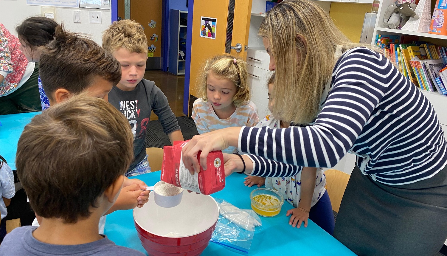Students learning about measurements with flour while baking.