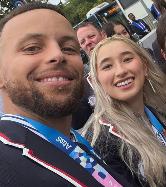 Maia taking a photo with Steph Curry at the opening ceremony