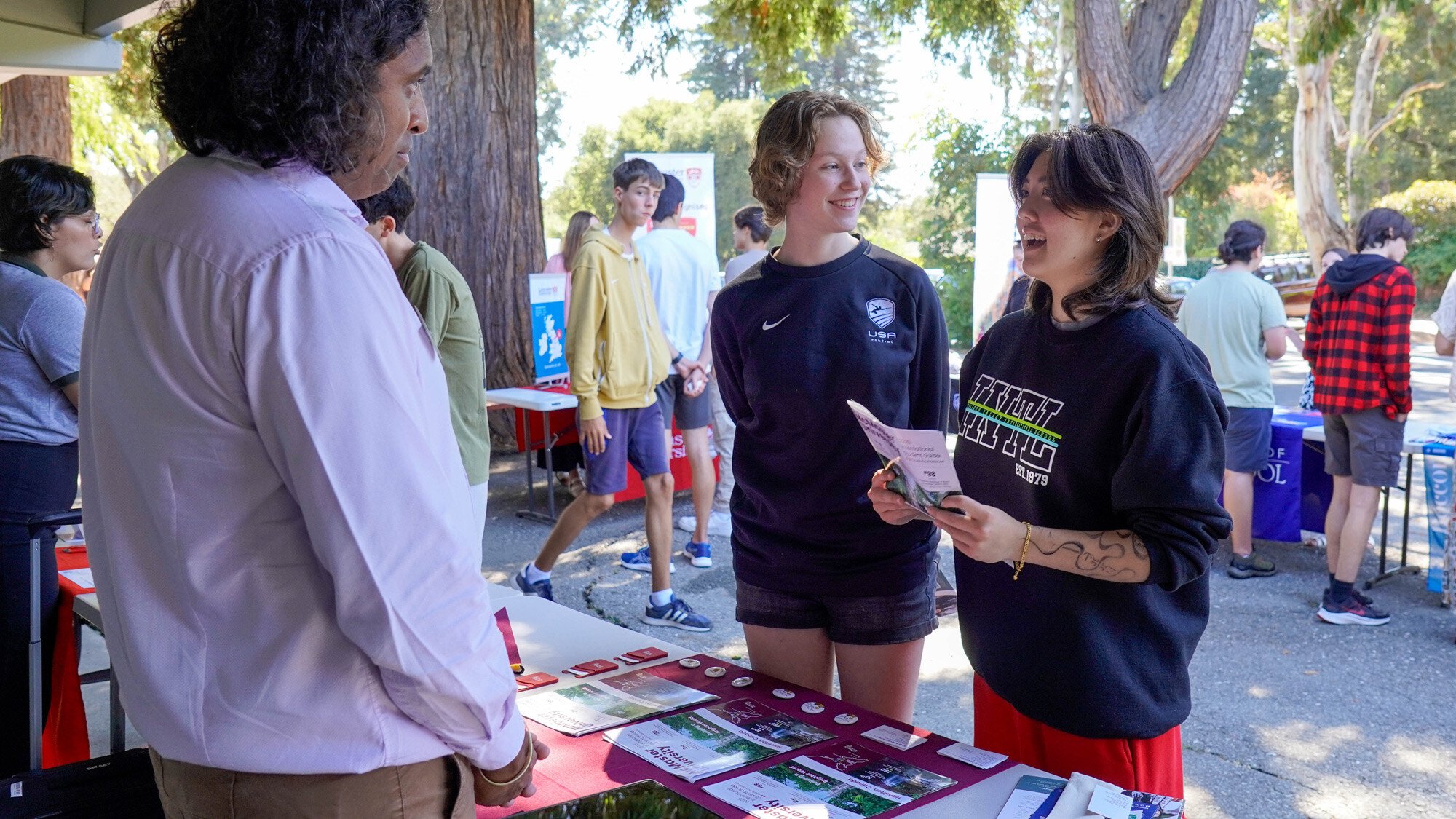 Two students gathering information at the mini college fair