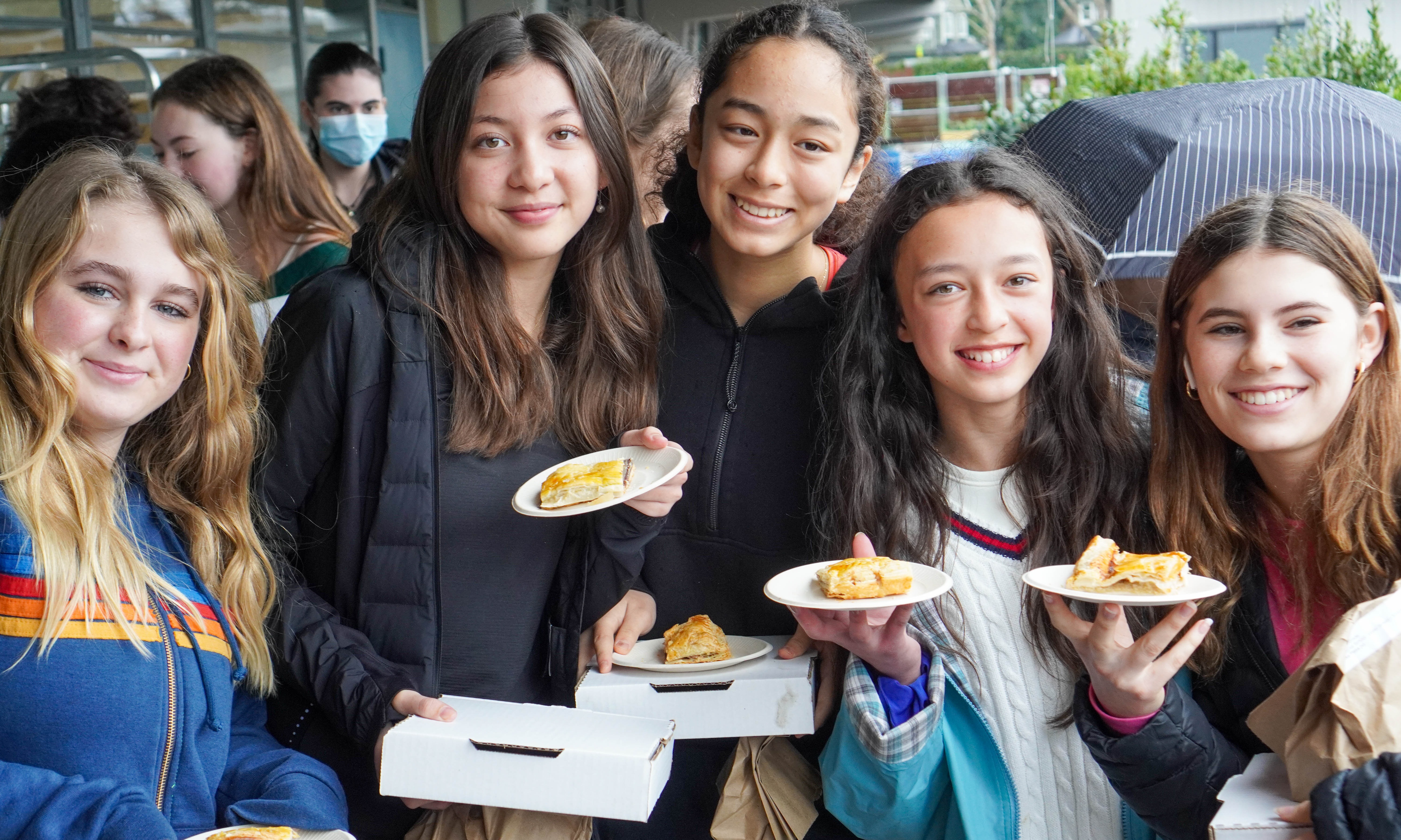 Five upper school girls showing off their galettes for the camera.