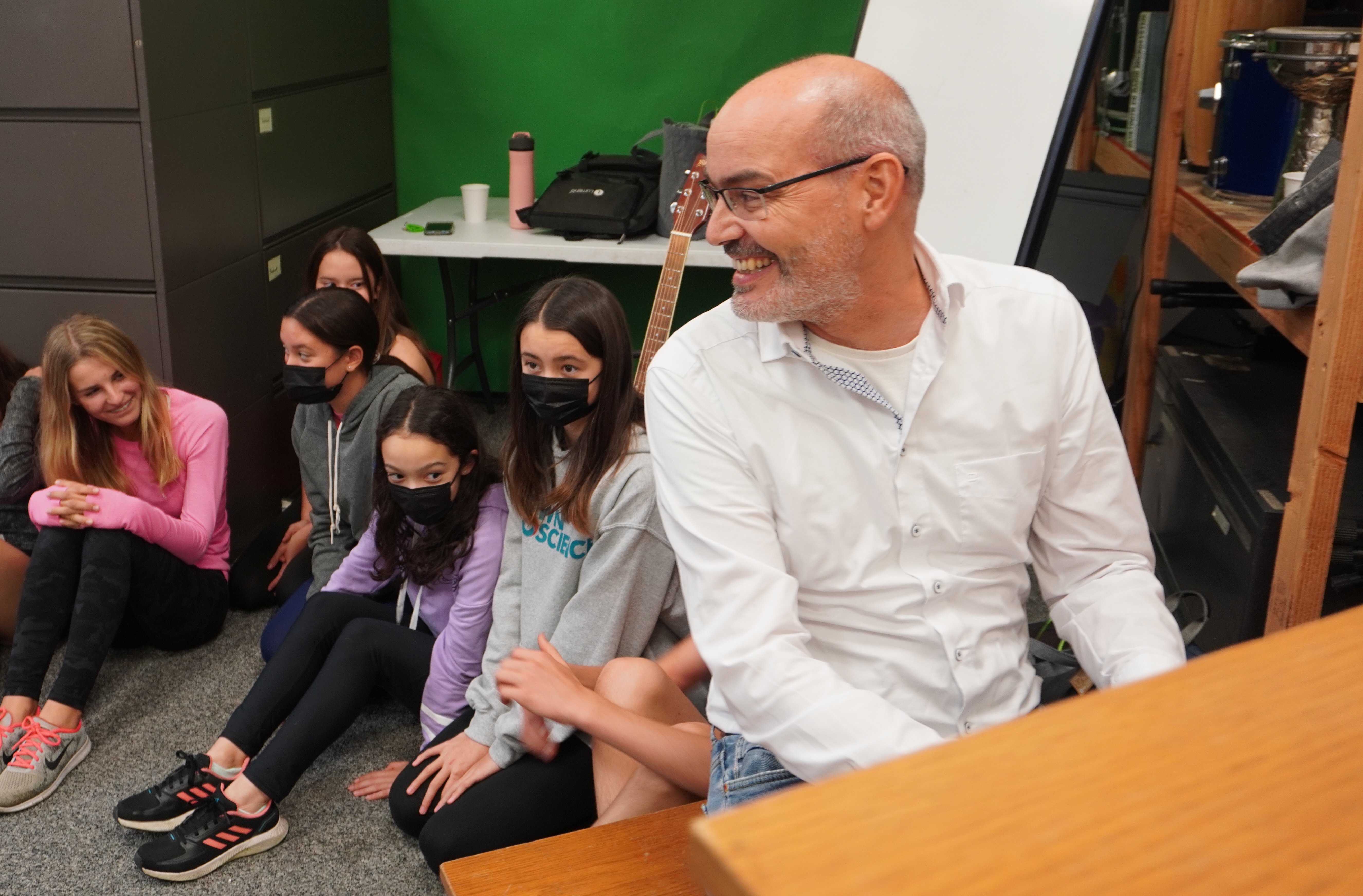 Frank Muschalle teaching the students about music while playing.