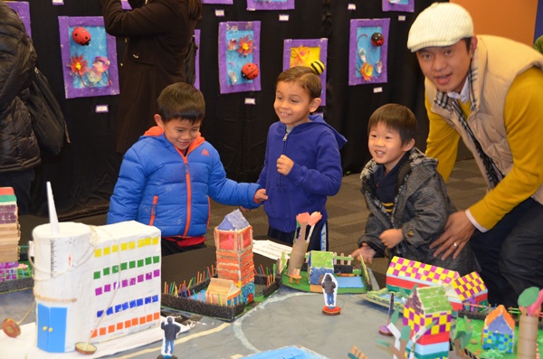 Students admire the village created by Yihui and David's class.