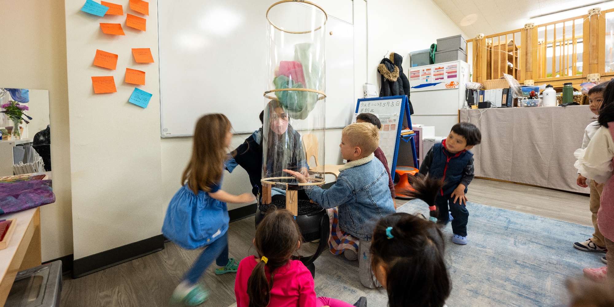 Early Years students learning about wind in a wind tunnel experiment.