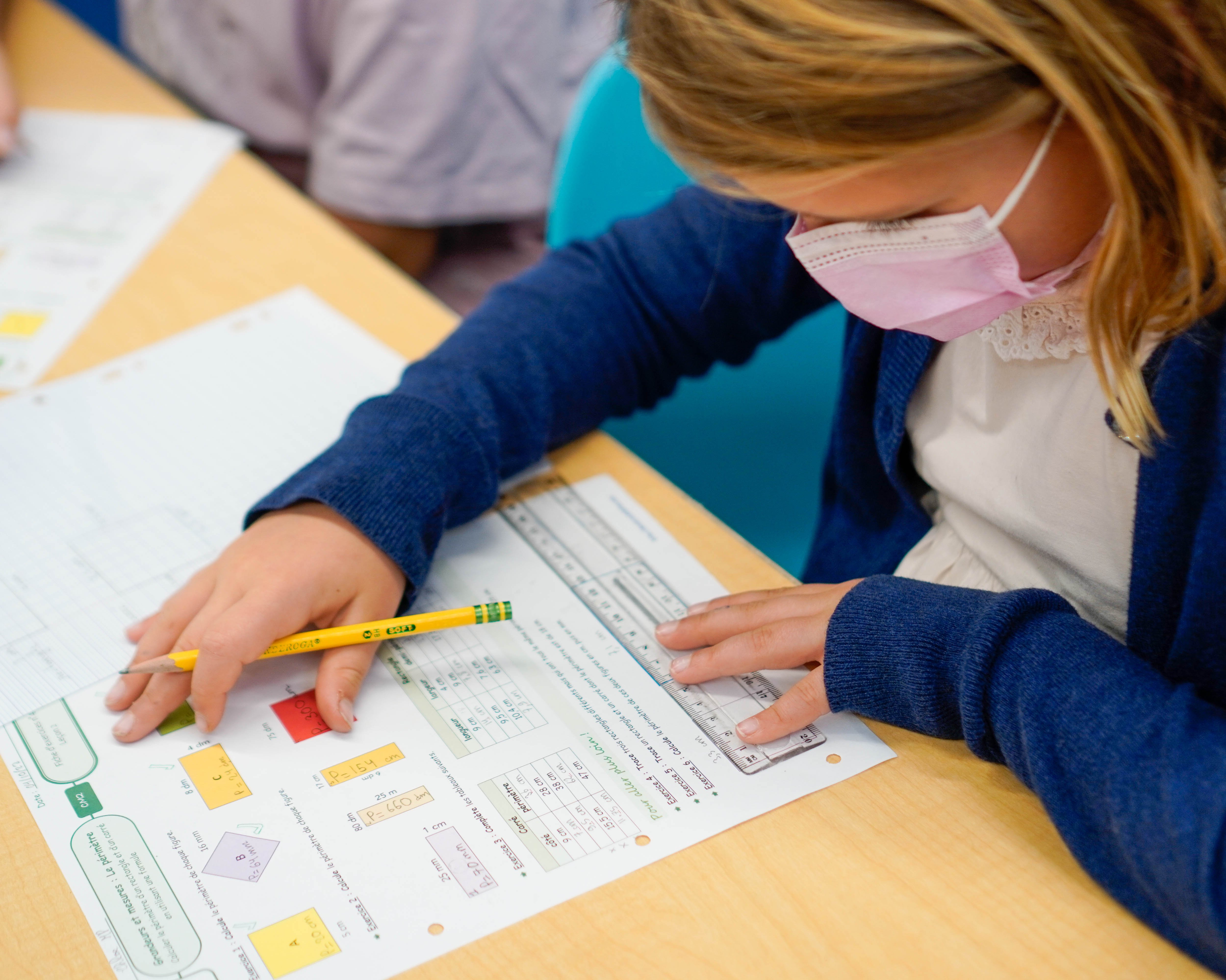 Students using a ruler for measurements as they begin learning the spacial concepts of shapes.