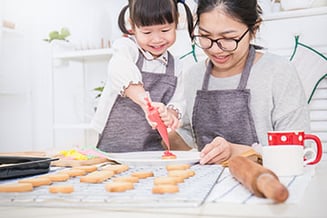 A mother and daughter cooking