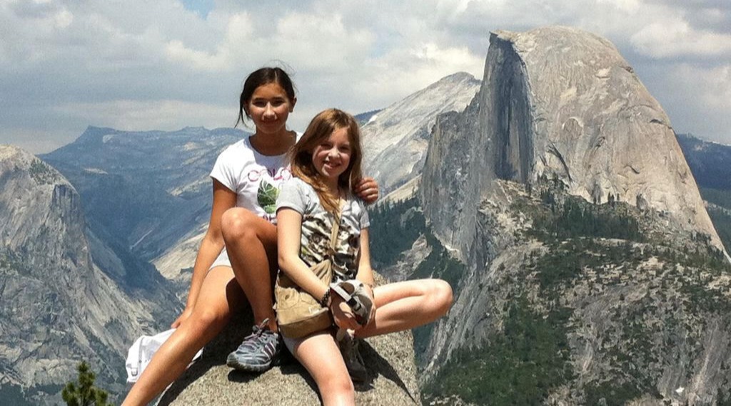 Maia (left) and her host sister sitting in front of Half Dome at Yosemite.
