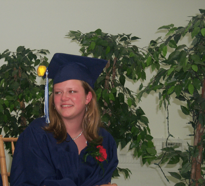 Eva in her cap and gown at 8th Grade graduation.