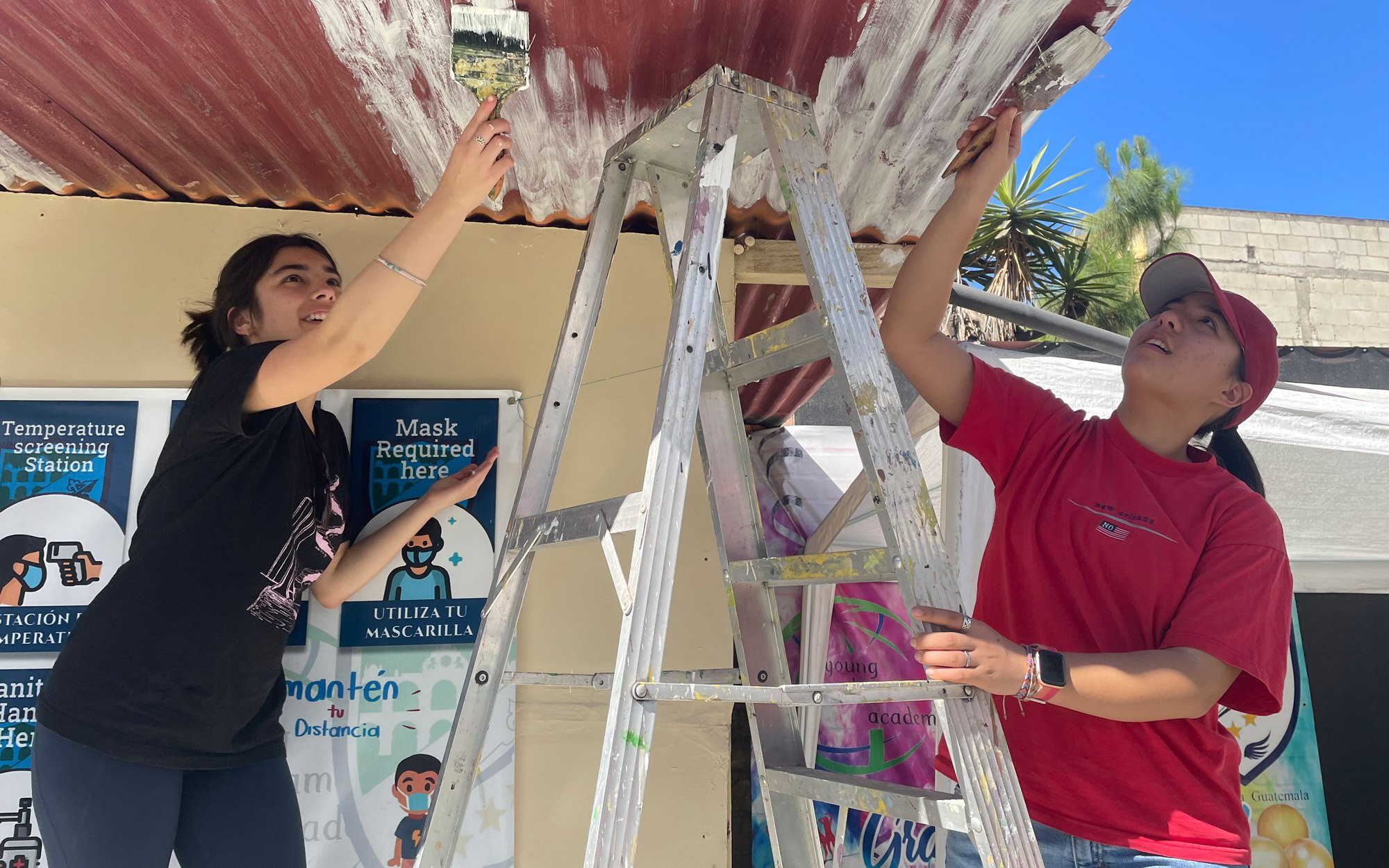 Service in Action, Rox painting a roof in Guatemala