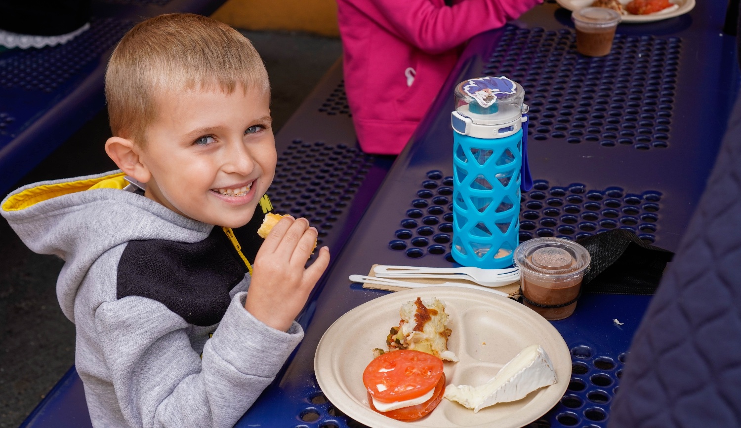 Elementary school student enjoying the French-inspired Taste Day meal at Cohn Campus.