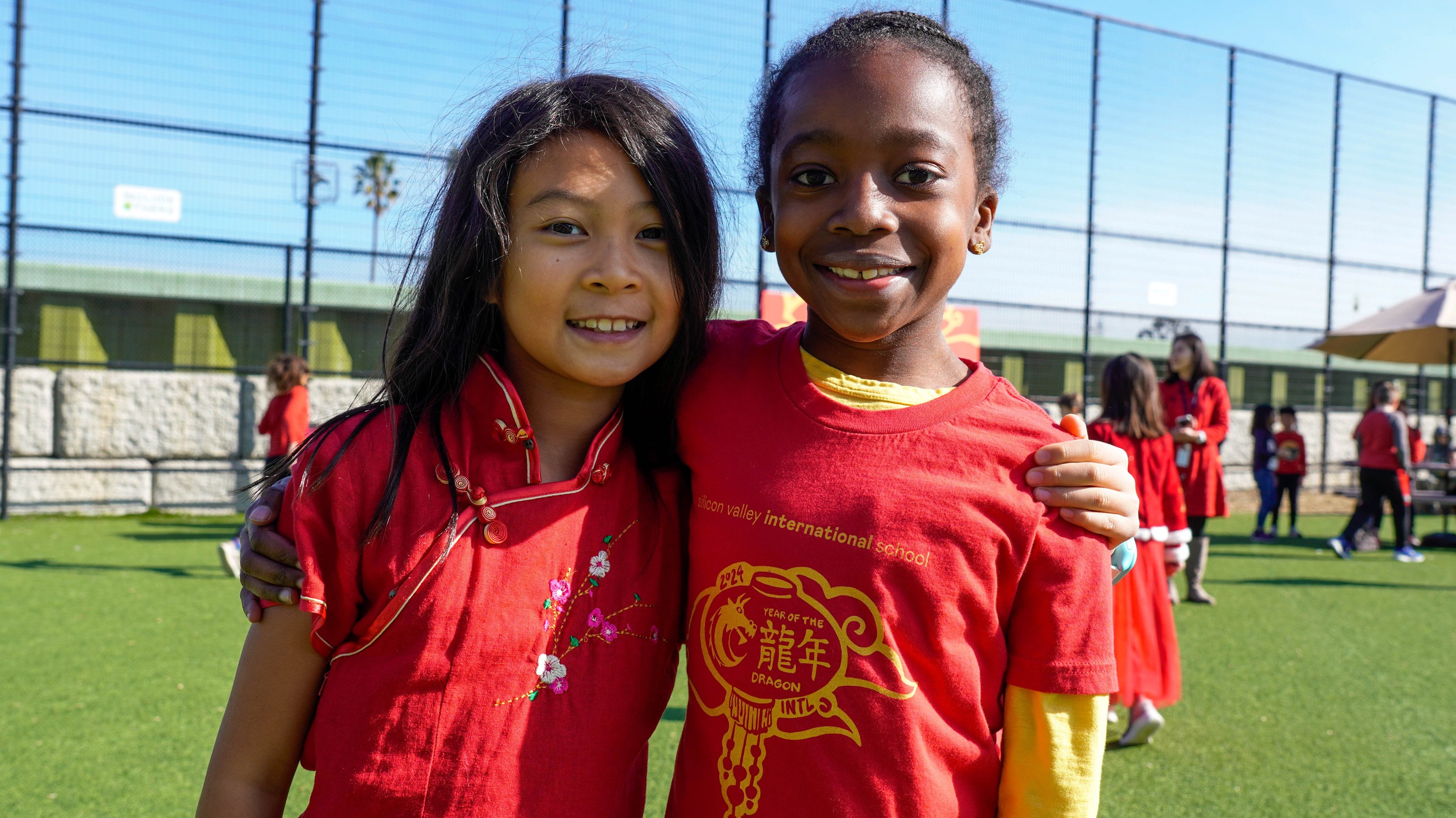 Two elementary students posing, one wearing the limited edition Year of the Dragon tshirt.