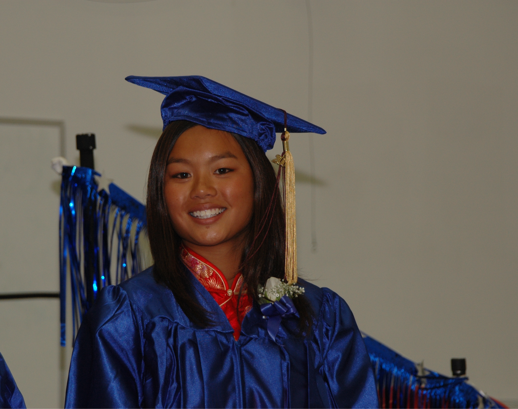 Sian in a gap and gown at her 8th grade graduation