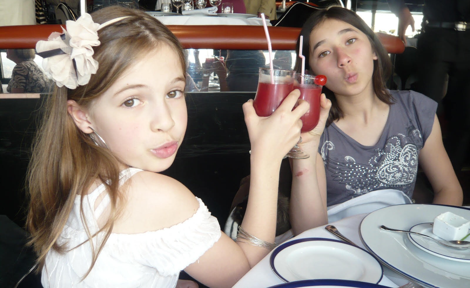 Maia (right) and her host sister with fruit drinks at a restaurant in France.