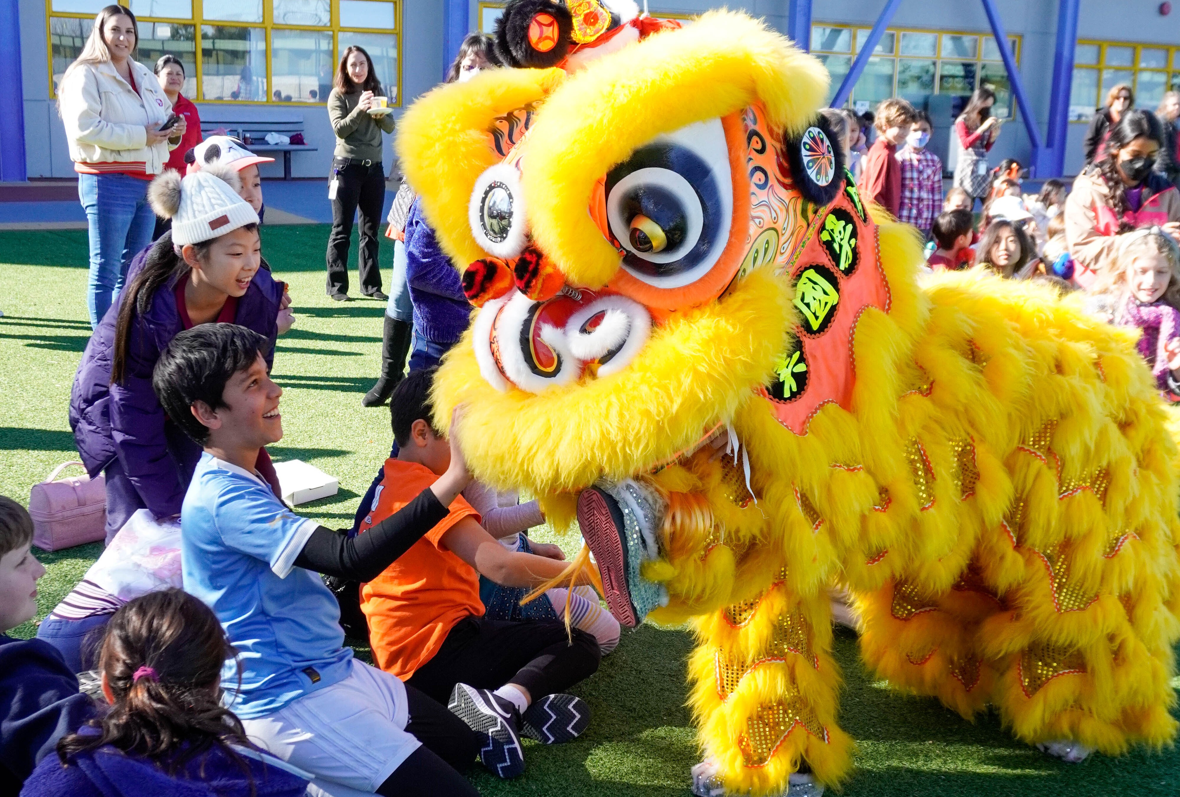 Students meet the lion dancers during the annual performance celebrating Lunar New Year.